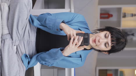 Vertical-video-of-Happy-and-happy-texting-young-woman.